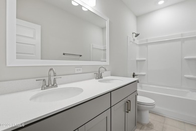The single-story Bates II plan features three bedrooms and two - photo 17