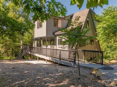 Tucked into 2.6 private acres, boasting Missouri hardwoods and - photo 2