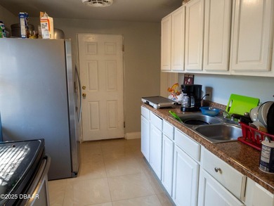 This cozy 3-bedroom, 1-bathroom concrete block home sits on a - photo 4