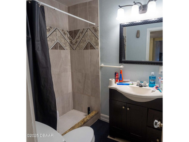 This cozy 3-bedroom, 1-bathroom concrete block home sits on a - photo 8