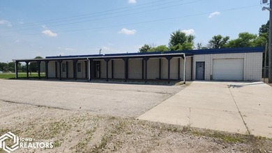 Former equipment dealership building on 1.27 acres at the west