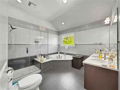 Built in 2013, this detached two-family home with brick front - photo 20
