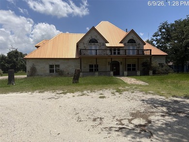 Set on 1.48 wooded acres along Lake Limestone, this custom stone - photo 1