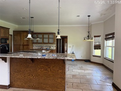 Set on 1.48 wooded acres along Lake Limestone, this custom stone - photo 9