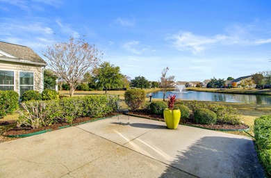 Pond living in this spacious, turn-key home in Del Webb Cane Bay