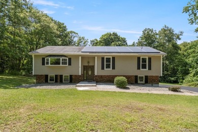 Tucked away on a beautifully wooded and private lot, this - photo 1
