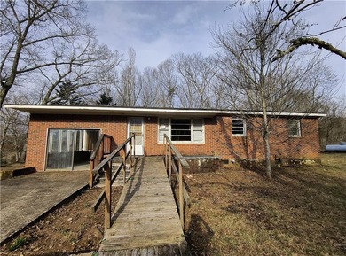 Solid built brick house that needs updating. Level lot with