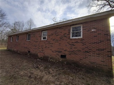 Solid built brick house that needs updating. Level lot with