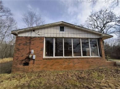 Solid built brick house that needs updating. Level lot with