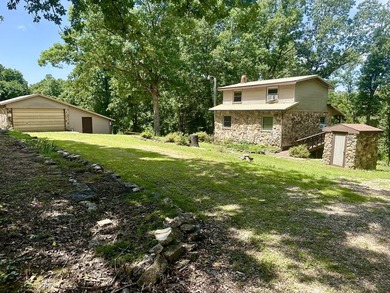 Nestled among mature shade trees, this private 10-acre Ozark - photo 2