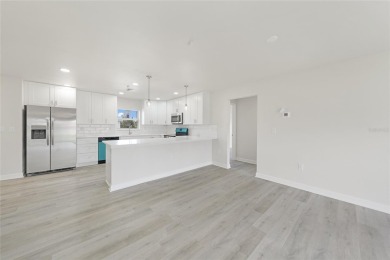 This nearly completed WATERFRONT TRIPLEX in Rotonda West, FL, is