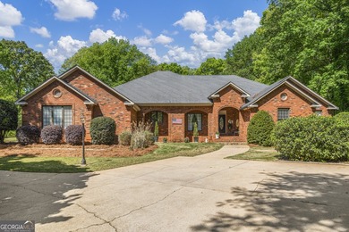 Welcome to this stunning four-sided brick lakefront retreat - photo 1