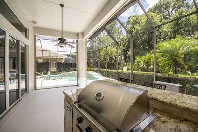 A private backyard oasis with a screened pool, outdoor kitchen - photo 7