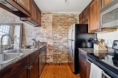 This charming, custom-designed two-bedroom condo at the historic