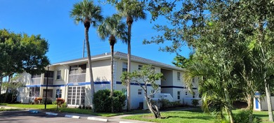 This updated ground floor unit features closed in porch; - photo 1