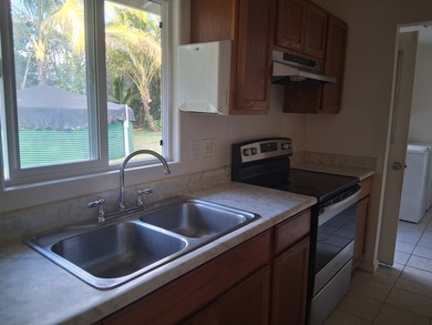 Well-maintained home with gated entry, rock walls, and a paved - photo 8
