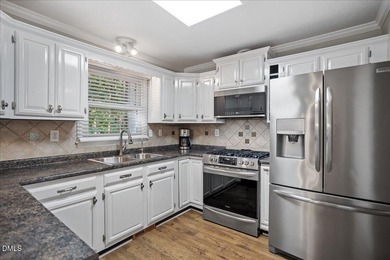 Set on a stunning, private one-acre lot, this three-bedroom