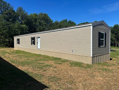 This BRAND NEW 3-bedroom 2-bathroom mobile home offers comfort - photo 1