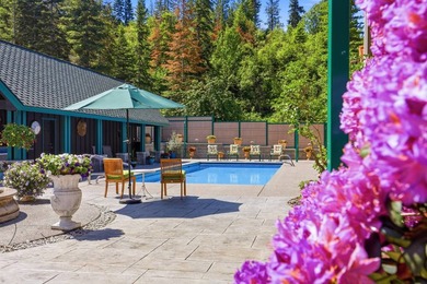 Perched behind a grand gated entrance and winding tree-lined - photo 4