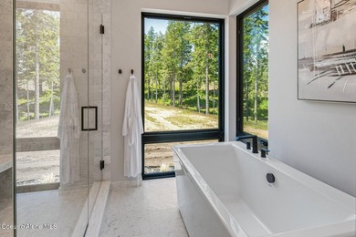 Set against a serene stand of forest, this spacious residence - photo 15