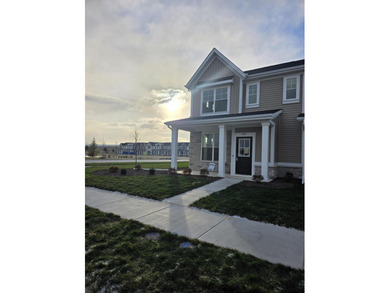 Enjoy the New Year in this move-in-ready end-unit Adler townhome