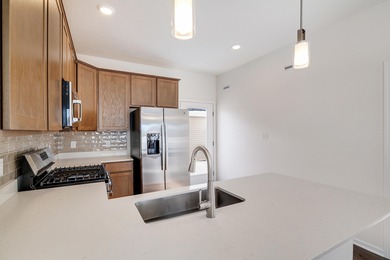 Enjoy the New Year in this move-in-ready end-unit Adler townhome