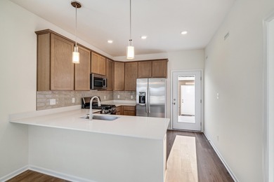 Enjoy the New Year in this move-in-ready end-unit Adler townhome