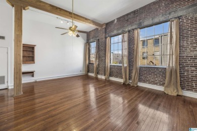 Exposed brick wall, floor to ceiling windows, exposed cedar