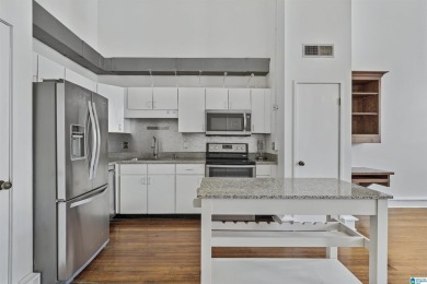 Exposed brick wall, floor to ceiling windows, exposed cedar