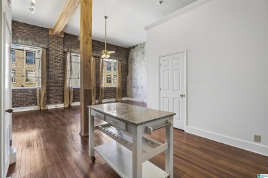 Exposed brick wall, floor to ceiling windows, exposed cedar