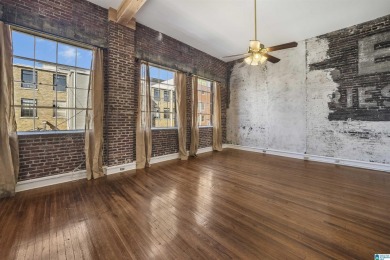 Exposed brick wall, floor to ceiling windows, exposed cedar