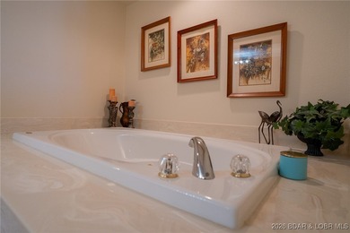 Elevate your Lake lifestyle in this premier Top Floor residence