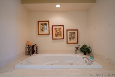 Elevate your Lake lifestyle in this premier Top Floor residence