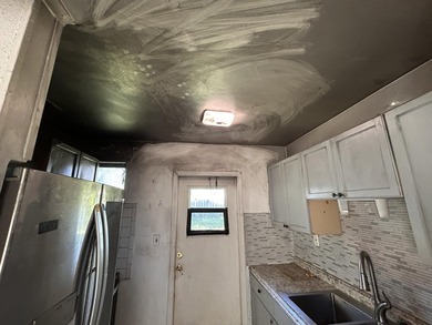 The kitchen appears to have experienced a stovetop fire - photo 10