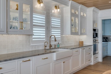 Welcome to 55 Walnut Road, a stunning bayfront masterpiece. This