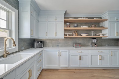 Welcome to 55 Walnut Road, a stunning bayfront masterpiece. This