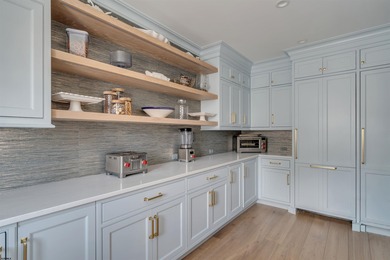 Welcome to 55 Walnut Road, a stunning bayfront masterpiece. This