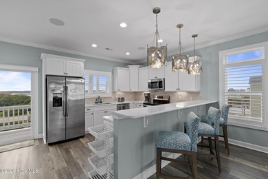 Located in North Topsail Beach, this custom-featured, truly