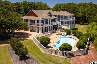 Tucked inside the gates of The Currituck Club, this six-bedroom - photo 1