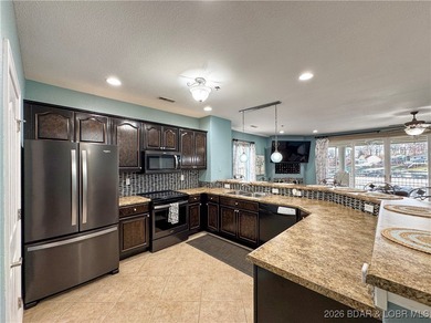 Welcome to Majestic Pointe Unit 1A, a rare end-unit in a gated