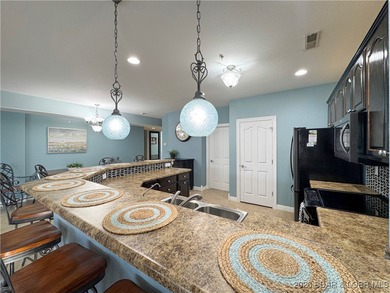 Welcome to Majestic Pointe Unit 1A, a rare end-unit in a gated