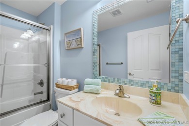 Welcome to Majestic Pointe Unit 1A, a rare end-unit in a gated