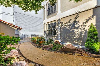 Welcome to Majestic Pointe Unit 1A, a rare end-unit in a gated