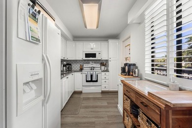 Positioned mere steps from the shoreline, this three-bedroom - photo 11