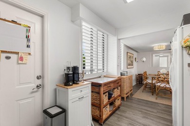 Positioned mere steps from the shoreline, this three-bedroom - photo 14