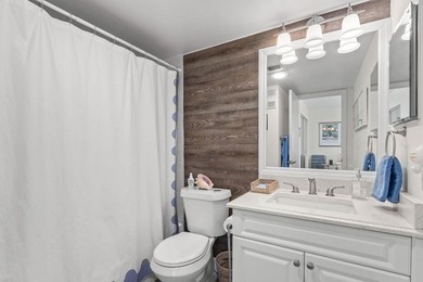 Positioned mere steps from the shoreline, this three-bedroom - photo 23