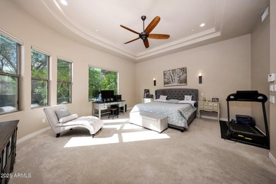 Positioned on an elevated, double-gated homesite within the