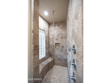 Positioned on an elevated, double-gated homesite within the