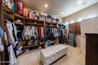 Positioned on an elevated, double-gated homesite within the