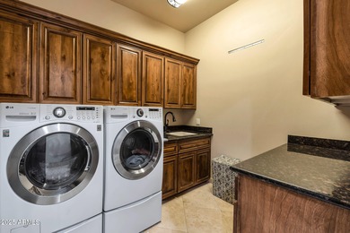 Positioned on an elevated, double-gated homesite within the